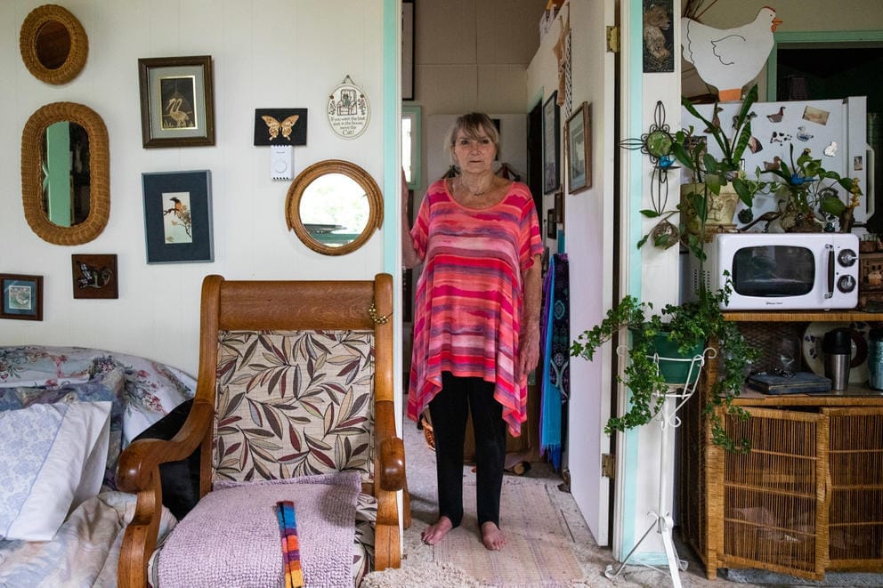 A woman stands in a doorway