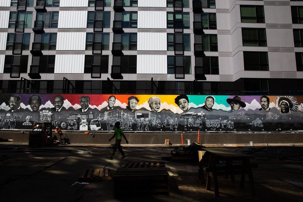 Colorful mural in red yellow green and blue in progress amid a construction site