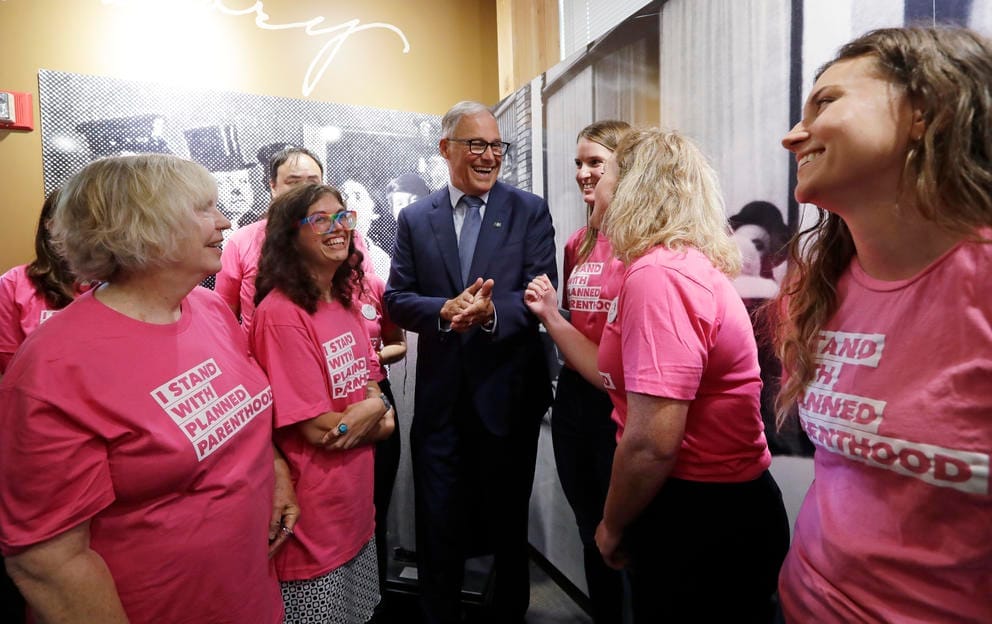 Gov. Jay Inslee talking with supporters of Planned Parenthood