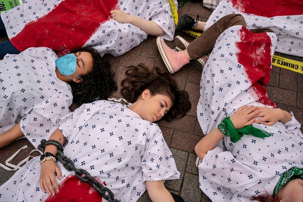 Demonstrators stage a “die in” on East Pine Street in downtown Seattle 
