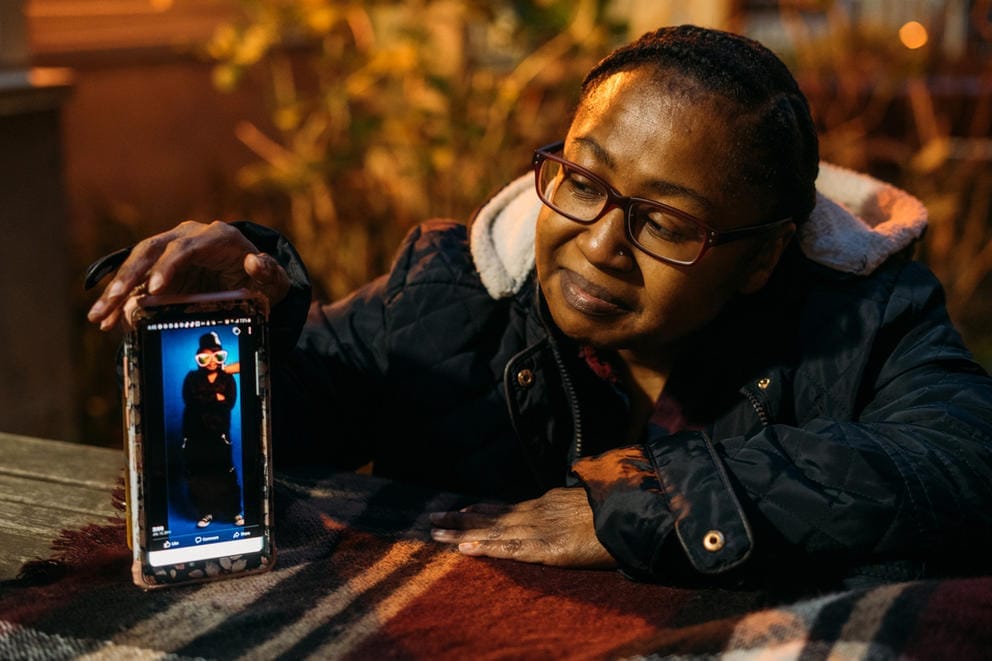Jamila McDaniel holds her phone on a table