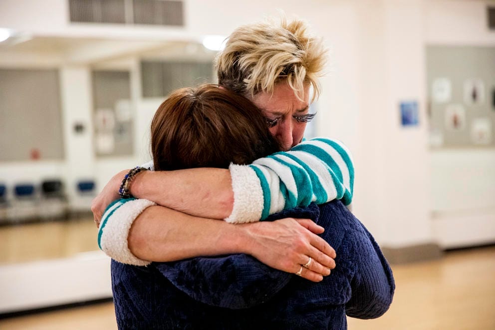 Hill and Lambert hug each other
