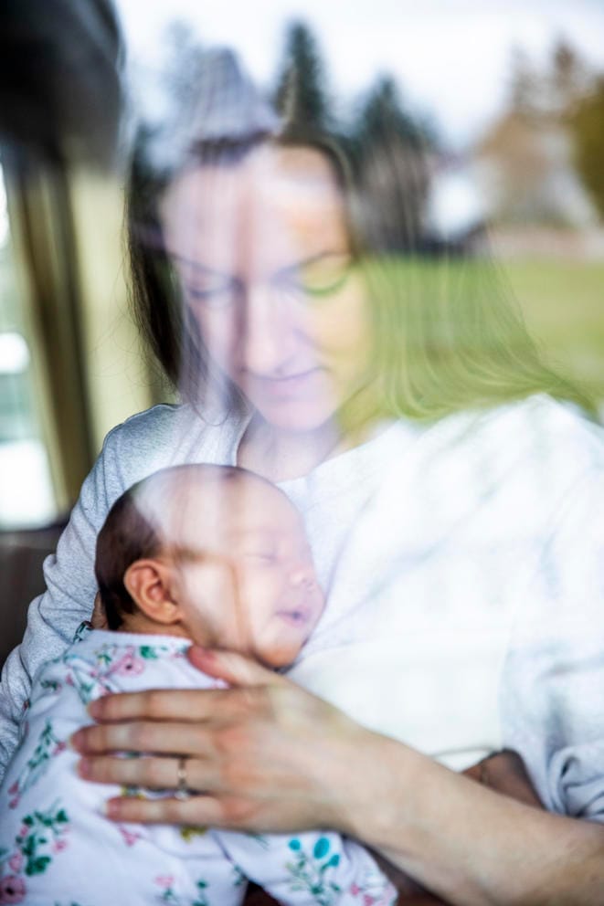 A mother holding her infant daughter