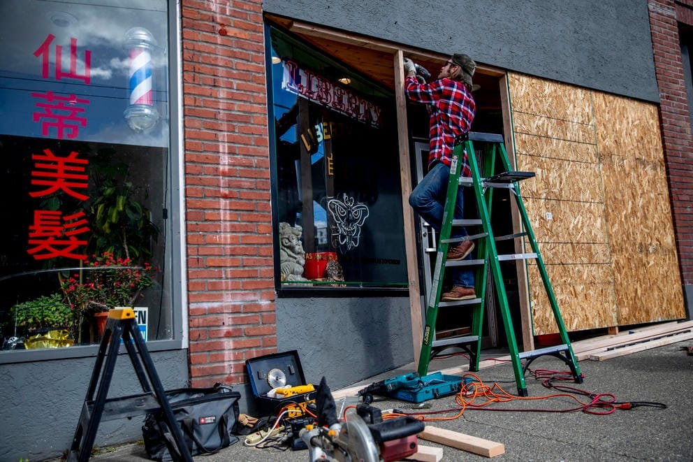 boarding up windows on a businesses