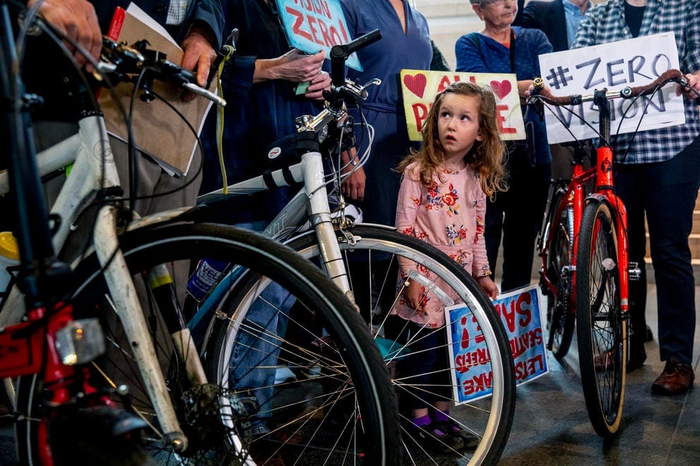 Ava Rigel looks up at bike protestors