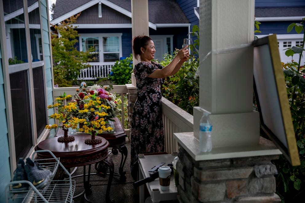 Nary takes a photo from the front porch