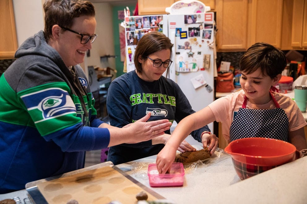 A family makes cookies in their kitchen