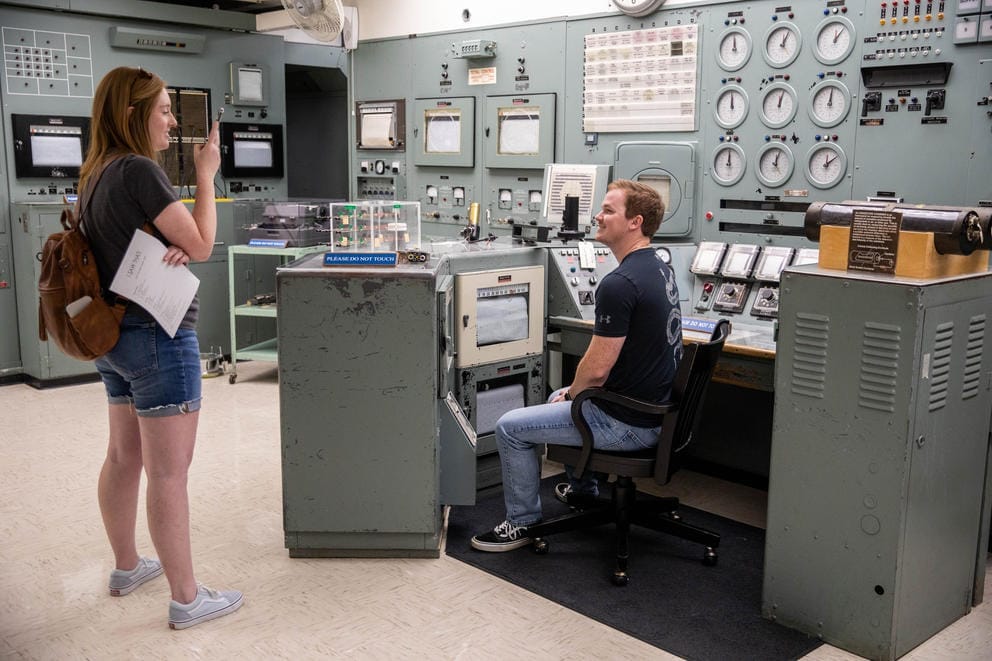 tourists taking pictures in the control room