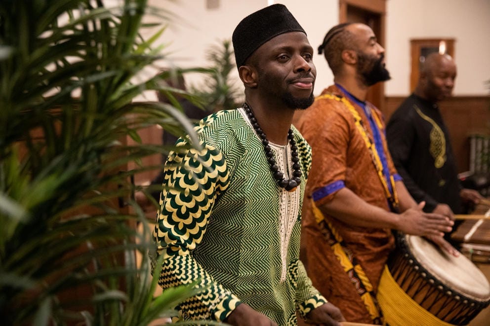 Men in traditional dress play the drums