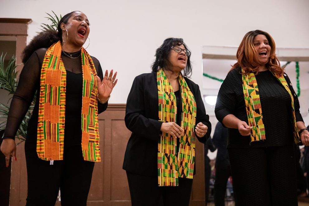 Three members of a choir sing