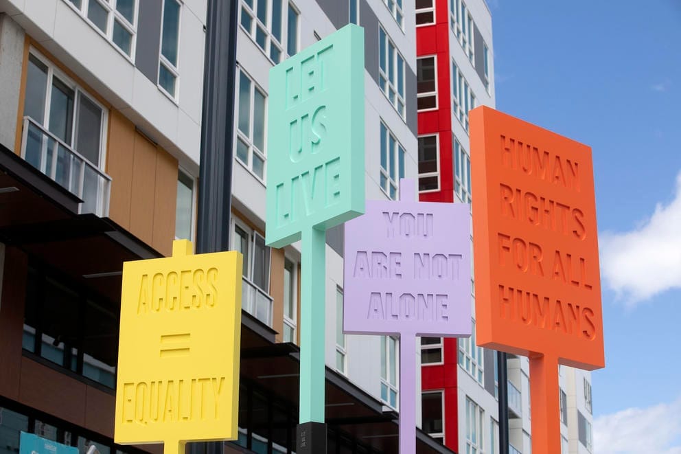 colorful panels out of metal with slogans debossed in them, such as