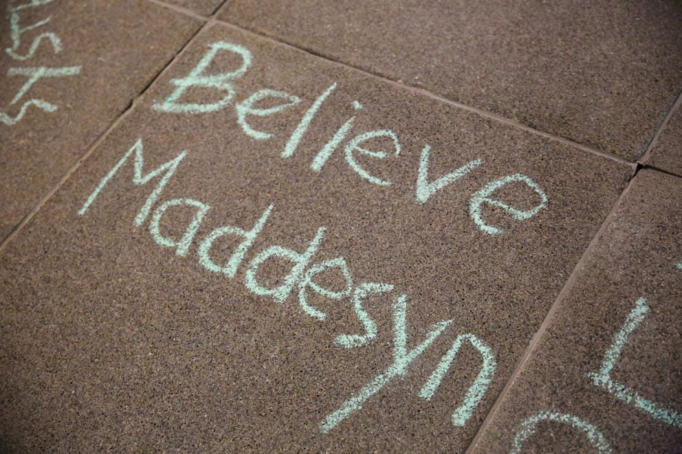 “Believe Maddesyn” is written in chalk on the sidewalk outside