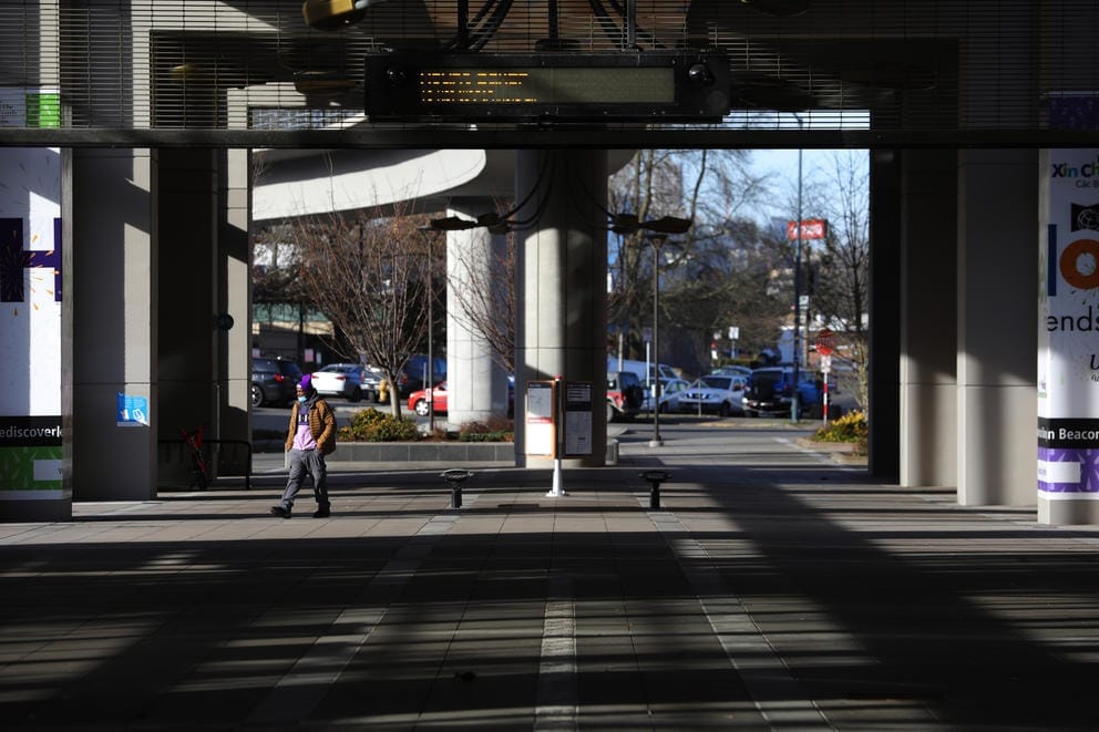 man walks underneath the mount baker station platform