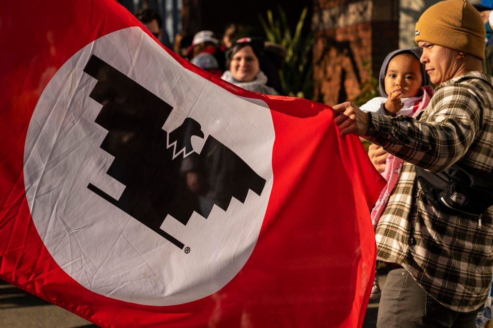 Demonstrator holding United Farm Workers flag