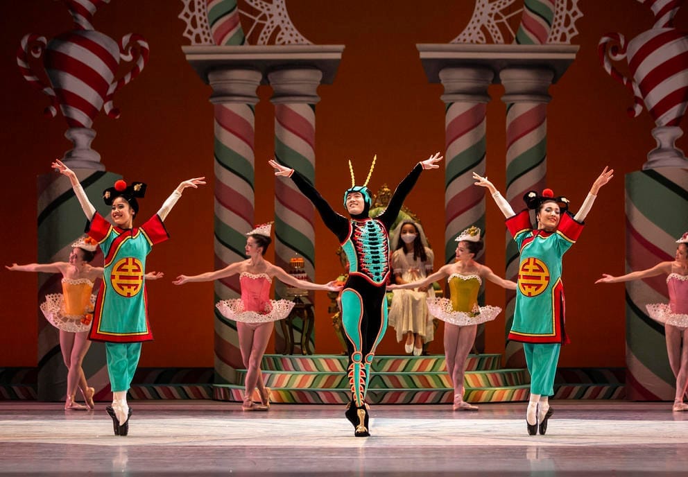 photo of three ballet dancers on stage in green costumes