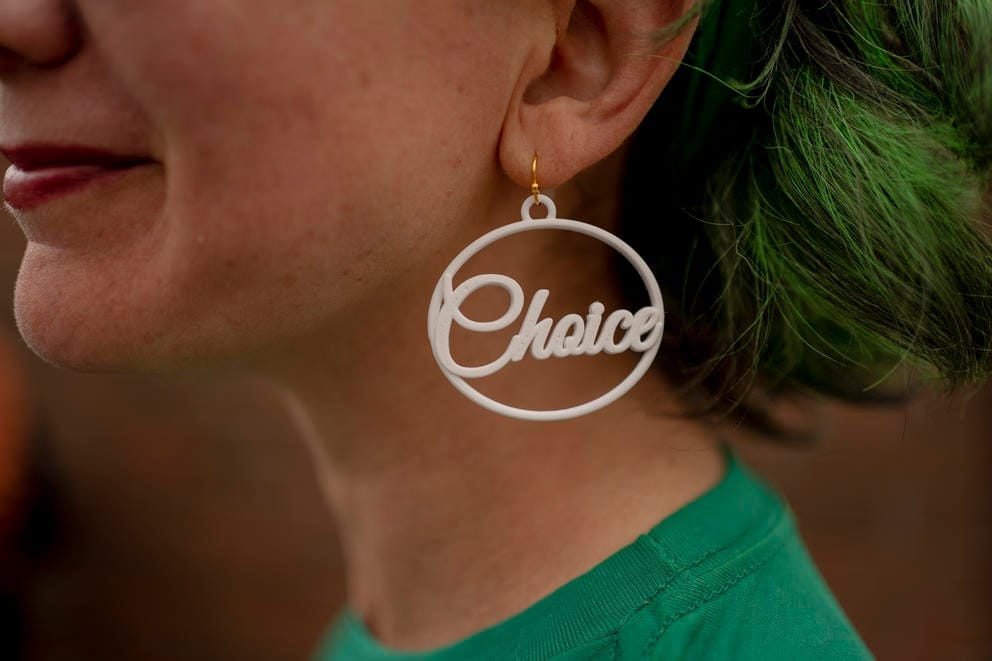 Close up: Emily Pinzur wears an earring that says “Choice,” which pairs with one on her other ear that says “Pro,