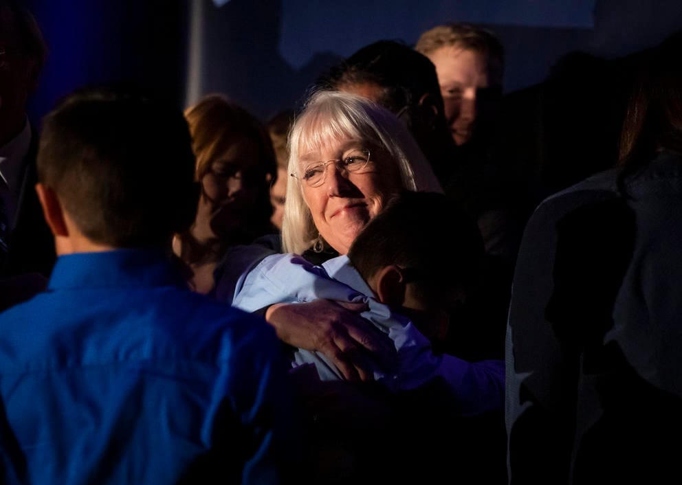 A close up of Patty Murray hugging a family member in a crowd
