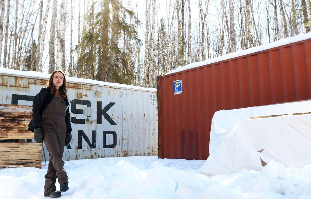 Kuperman stanfing in front of 40-foot-long shipping containers