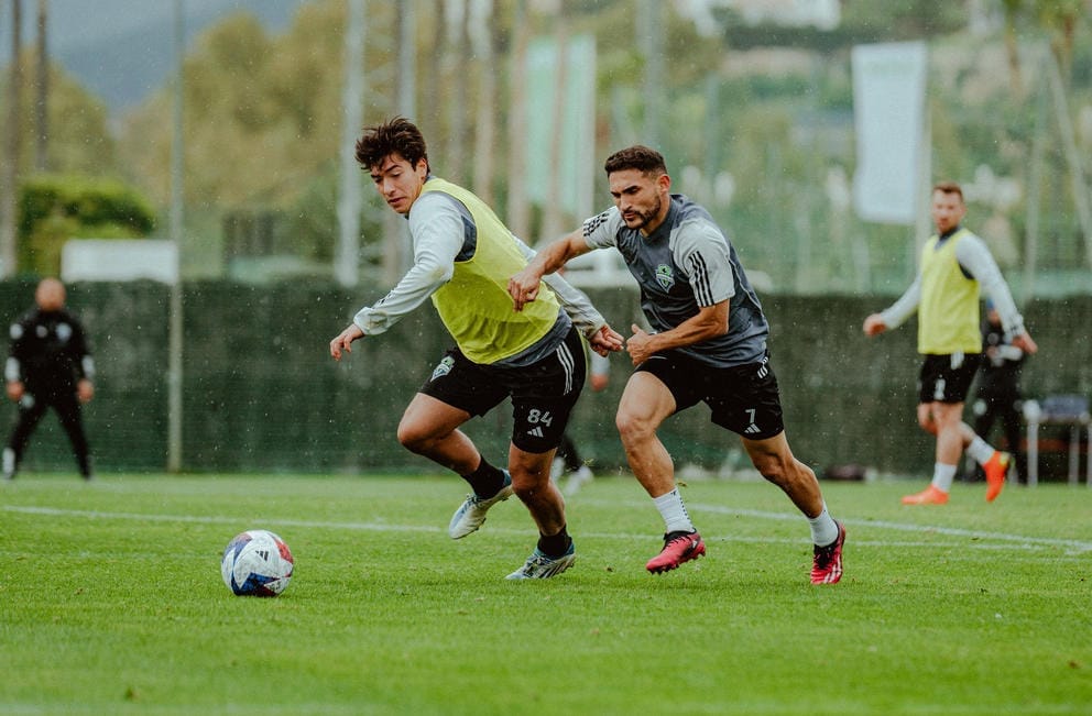 Two players chase a soccer ball