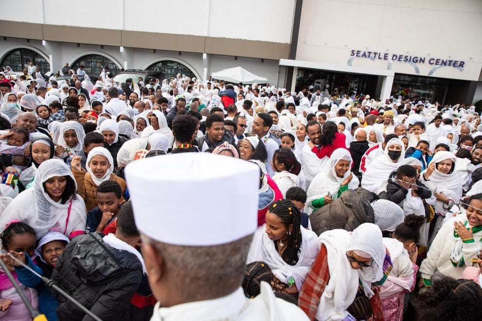 A crowd of people in white religious garb