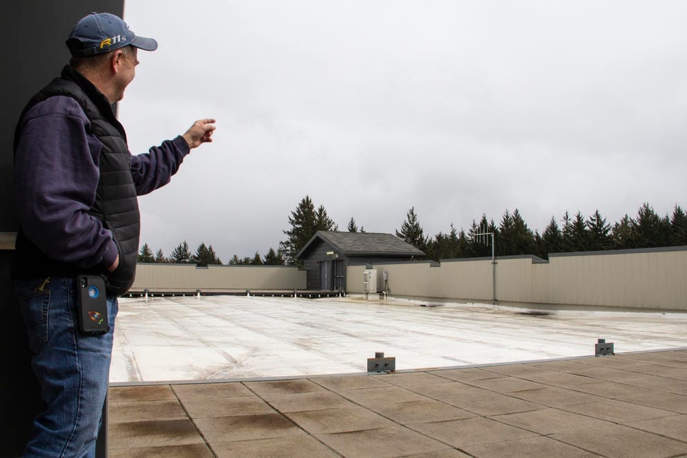 Facilities Director for Ocosta School District Steve Schmelling shows the roof of Ocosta Elementary School in Westport