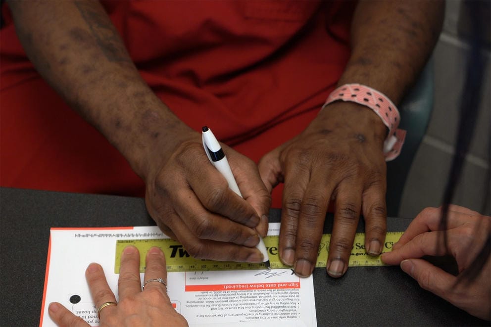 Jordan Landry as he signs his ballot for the November 2019 election