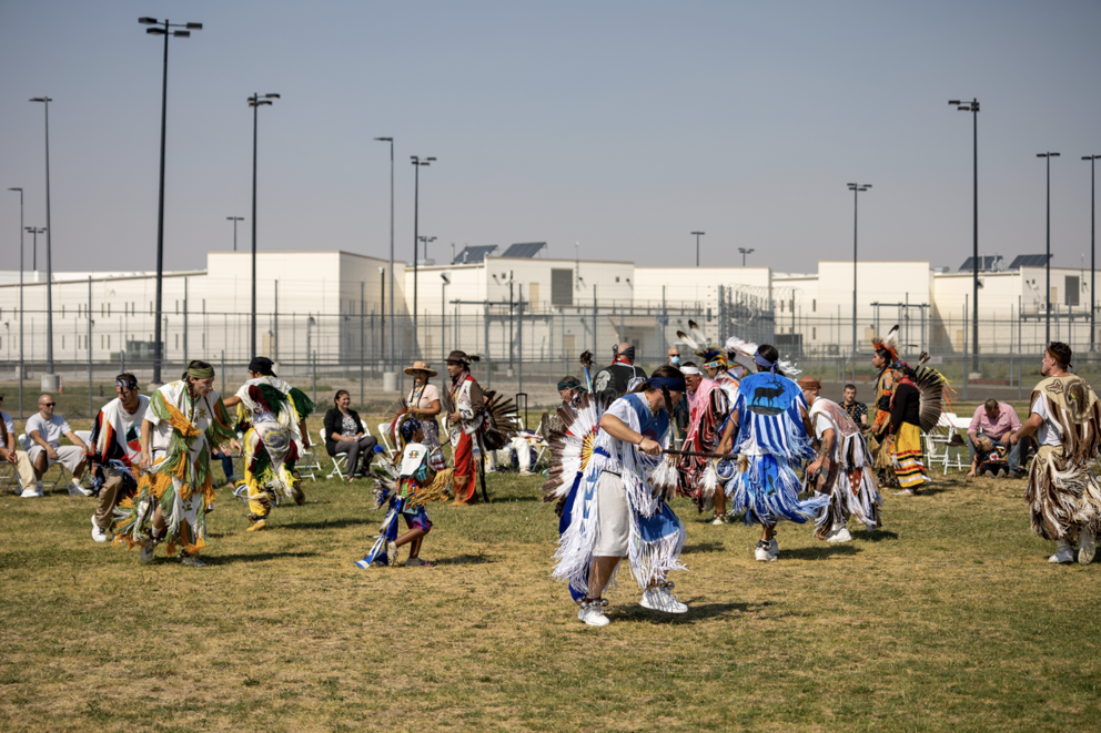 Families in regalia dancing