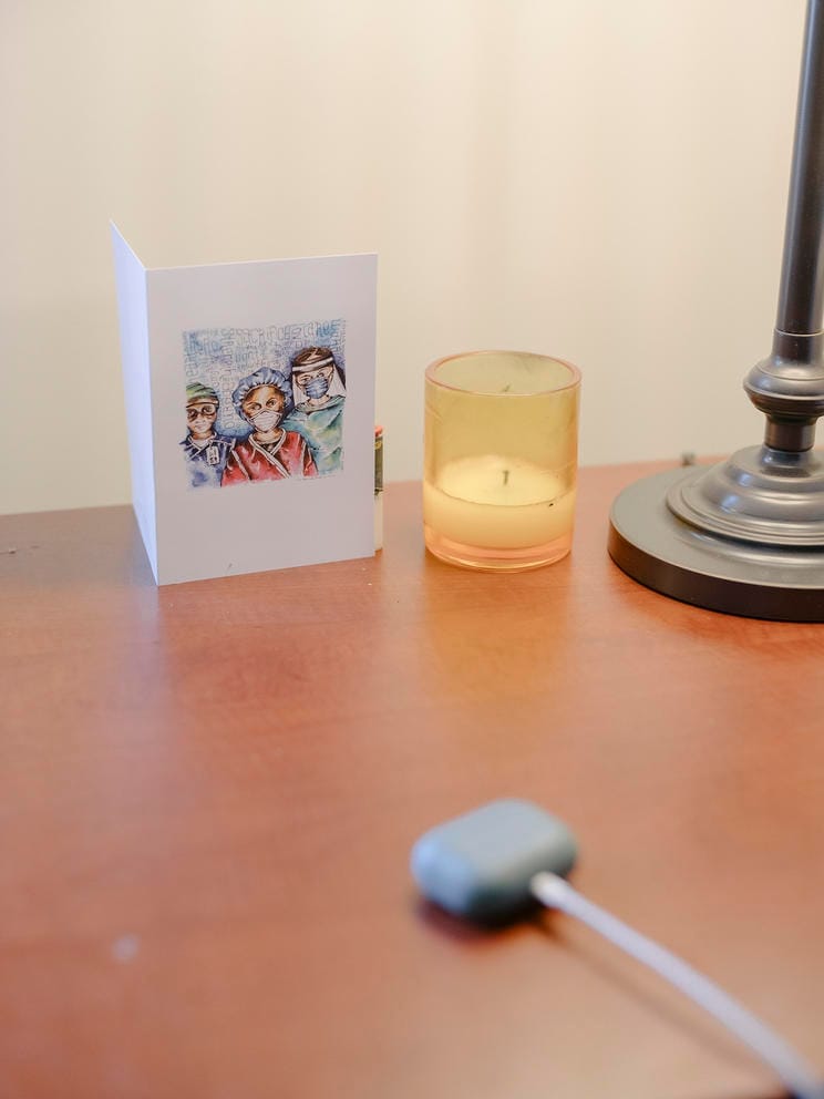 Greeting card and candle rest on a desktop