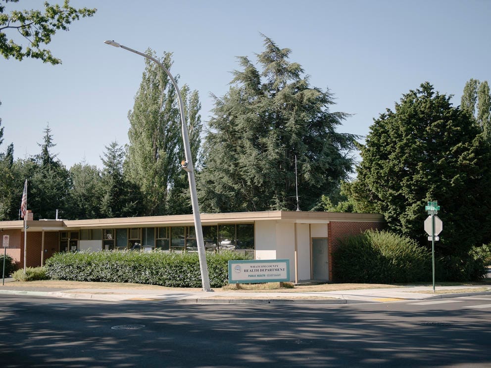 A one-story building backed by trees