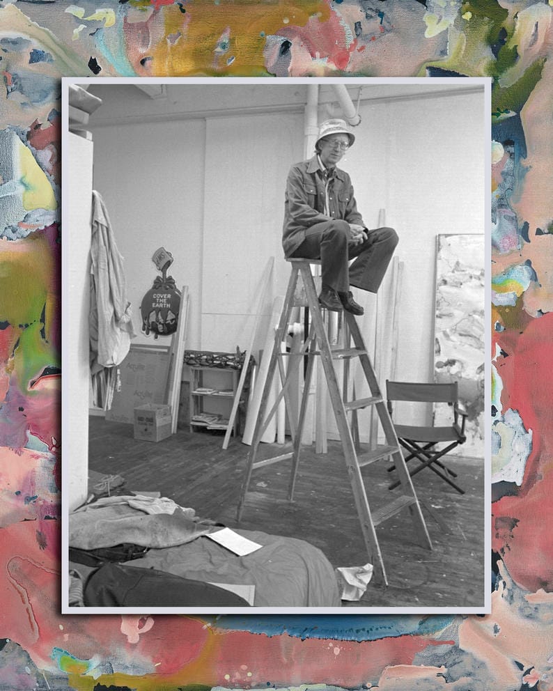 Black and white photo of someone on a ladder in a gallery