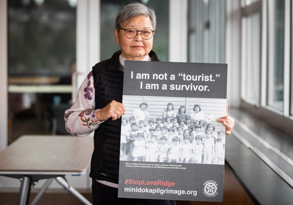 Mary Tanaka Abo holds a sign 
