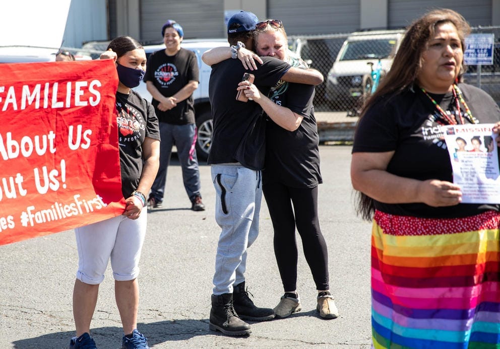 Rhonda Taylor, center right, mother of Shaulina Bulltail, hugs Andre Anderson, her nephew