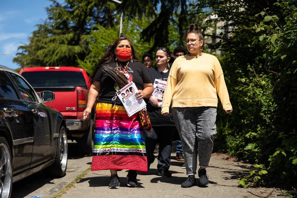 Roxanne White, left, and Tashina Bulltail walks to a homeless encampment