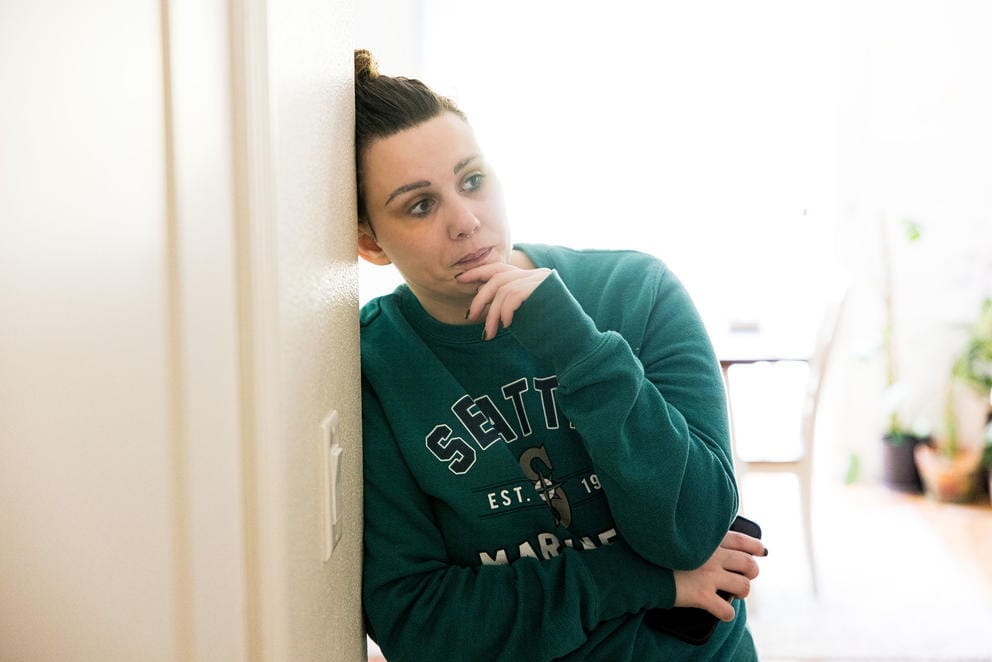 Amanda Klinksiek leaning on a door in her home at JBLM