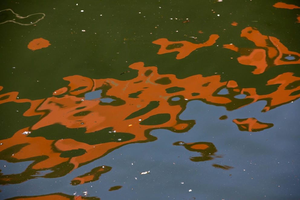 a reflection of a barge on the water
