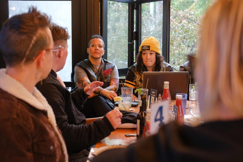 A group of women sit around a table at a restaurant
