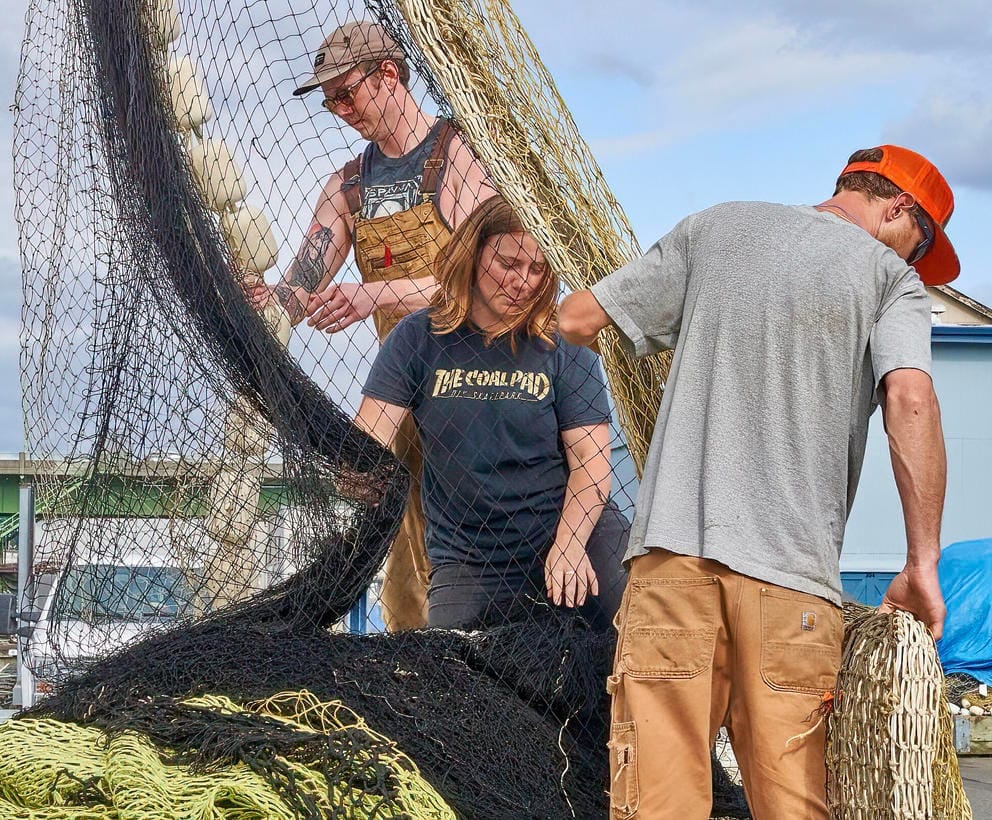 Brigett Cronk pitches in stacking the nets for the FV Wonderland trip to Alaska. 