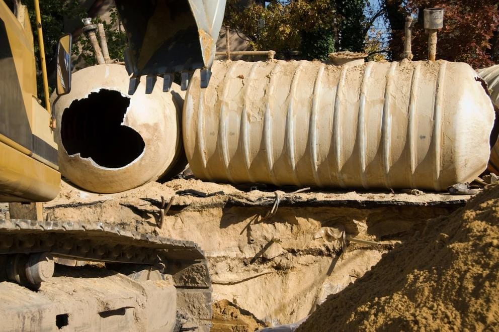 Workers remove an underground tank from a gas station.