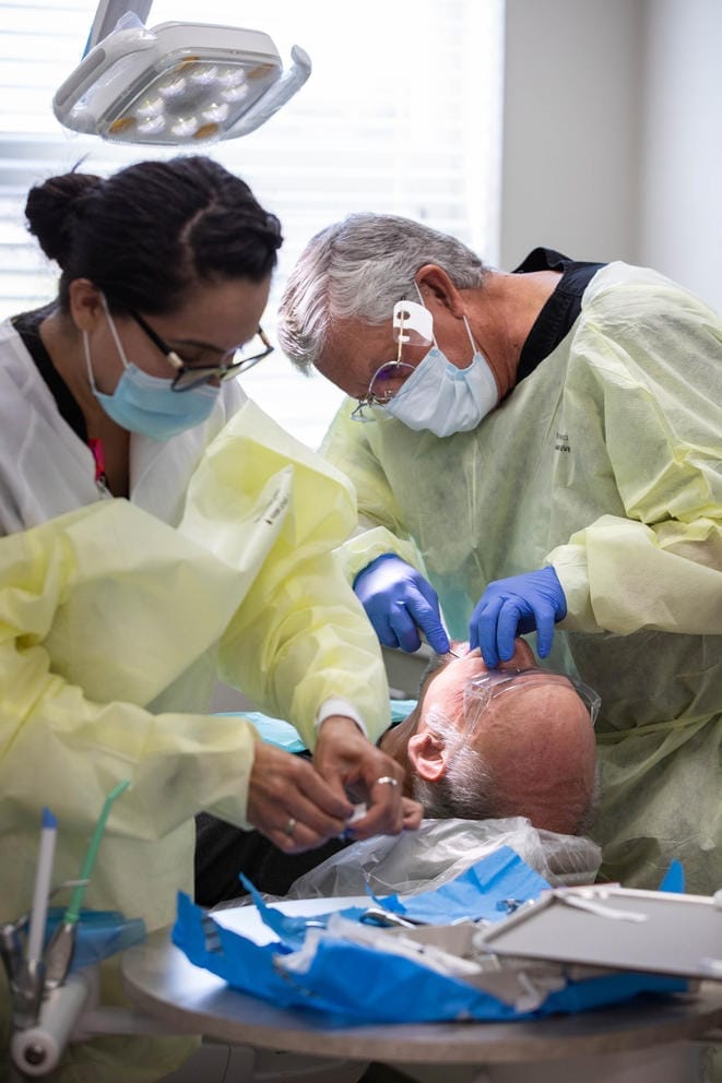Michael Shay is seen by a dentist for a tooth extraction at the on-site clinic at Chuck Austin Place