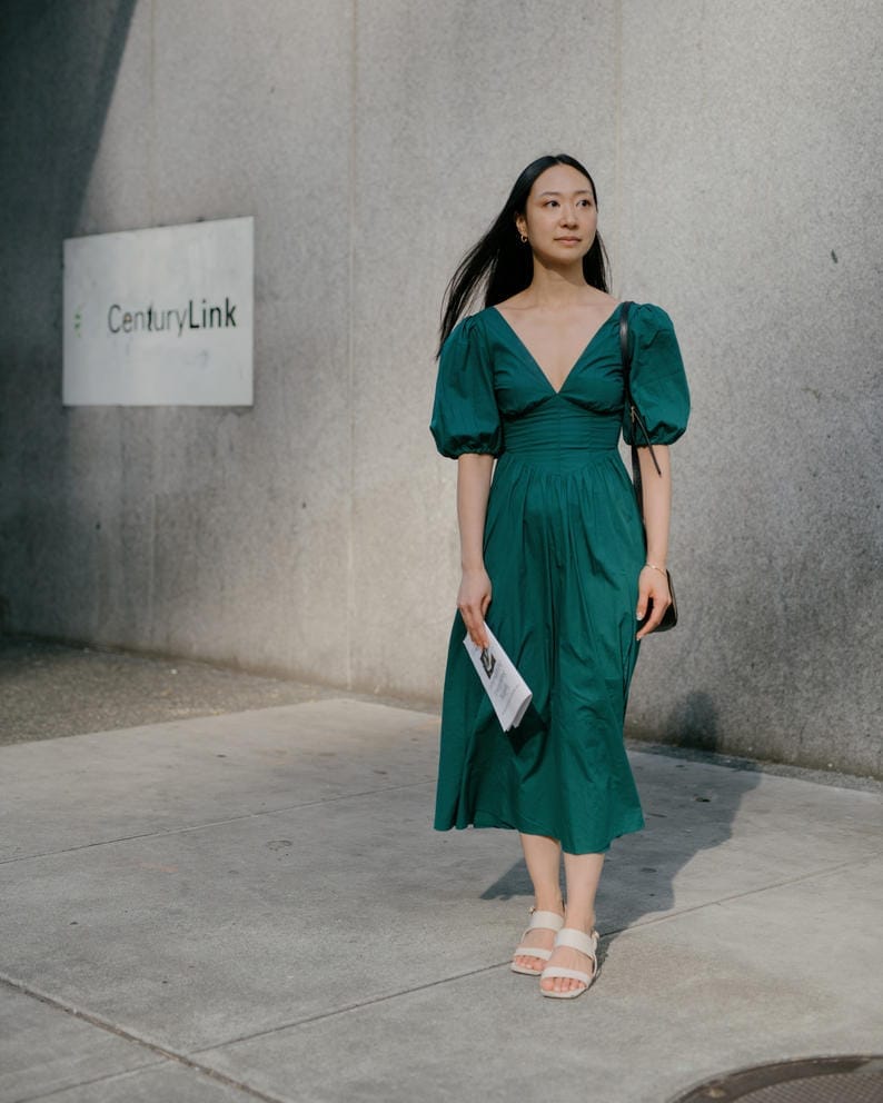 Jennifer Lee stands for a photo in a green dress.