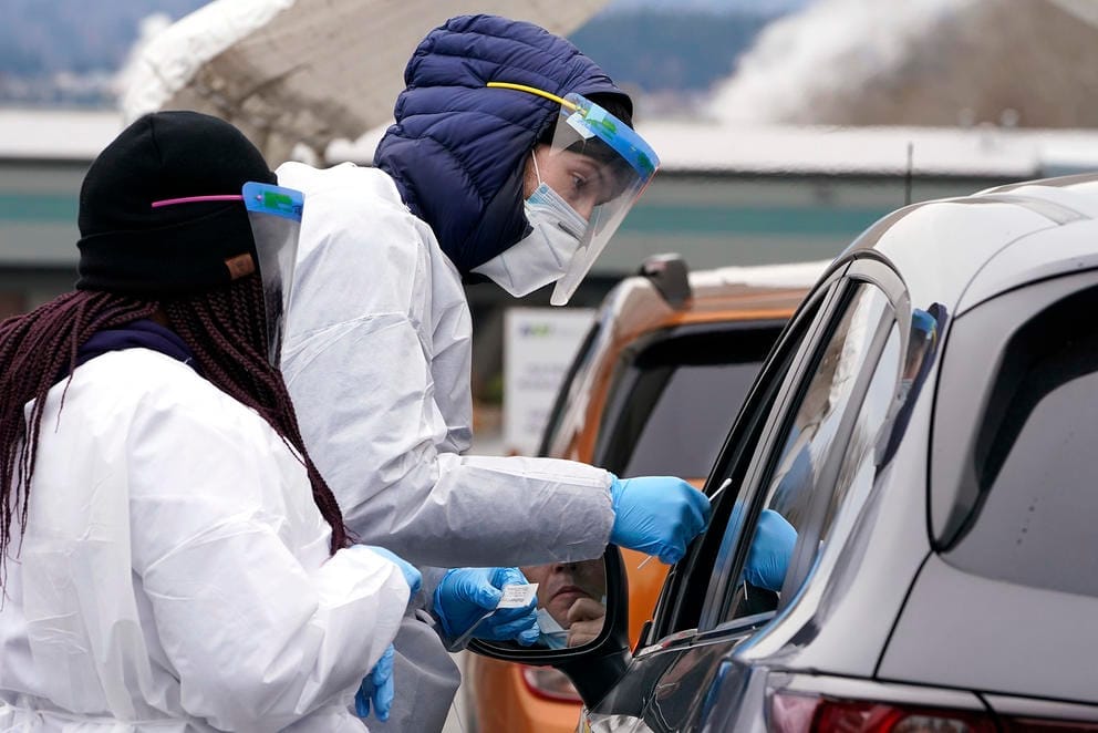 people in a car getting a covid test