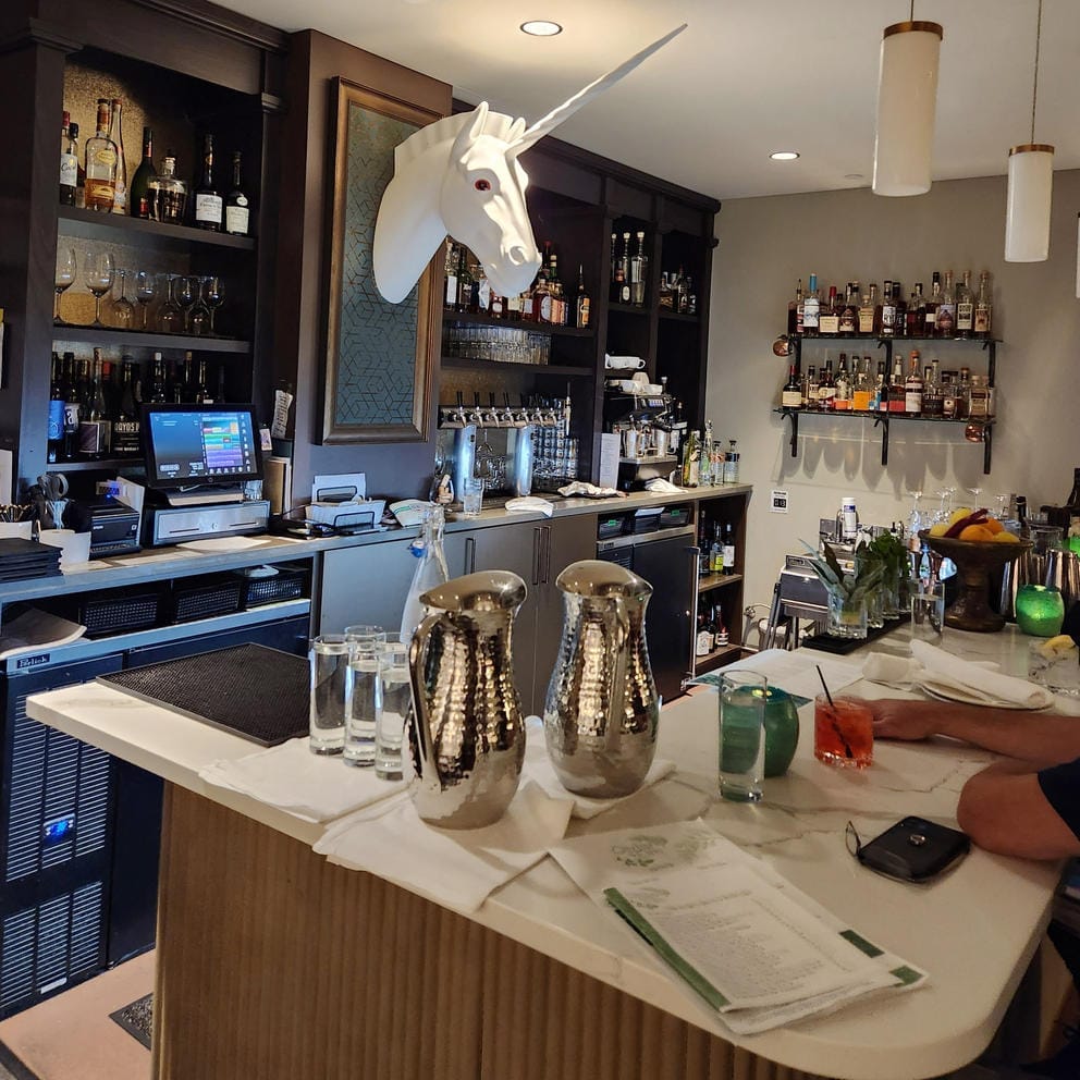 A unicorn watches over the Tonsorium Bar inside The Lodge at St. Edward Park