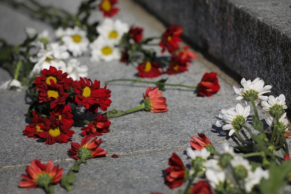 Red and white flowers lay on steps