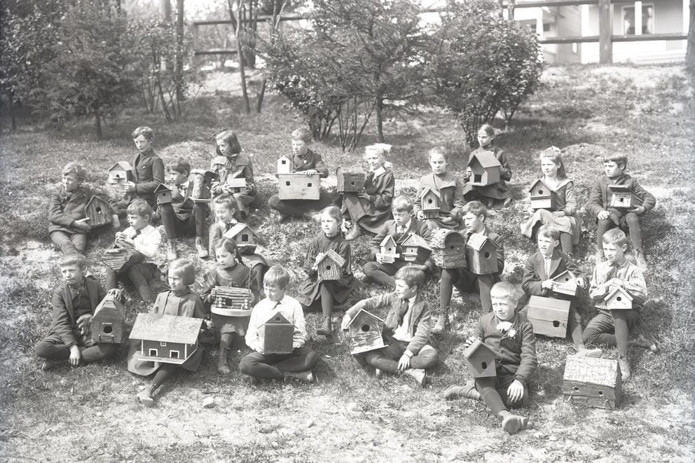 Class posing with birdhouses.