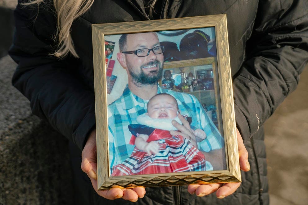 A close up of a framed photograph of a man and a baby.