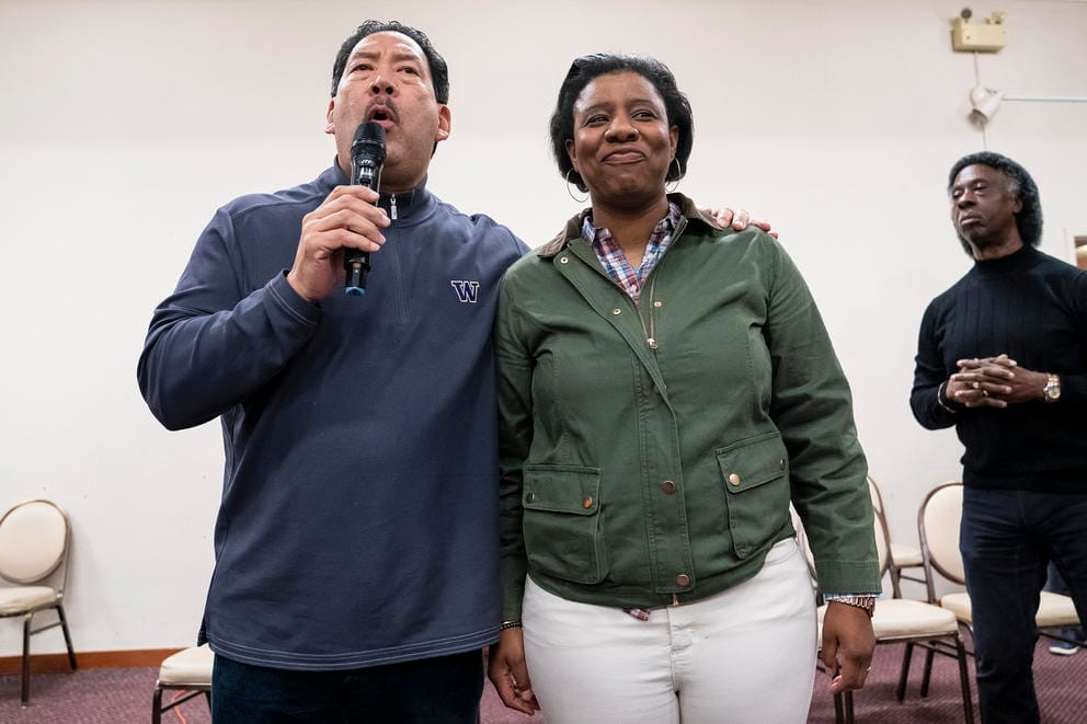 a man and woman stand together on a stage
