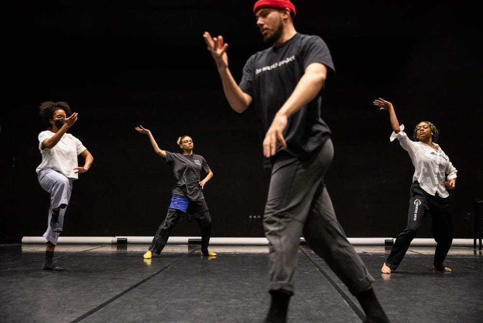 four dancers rehearse in a studio