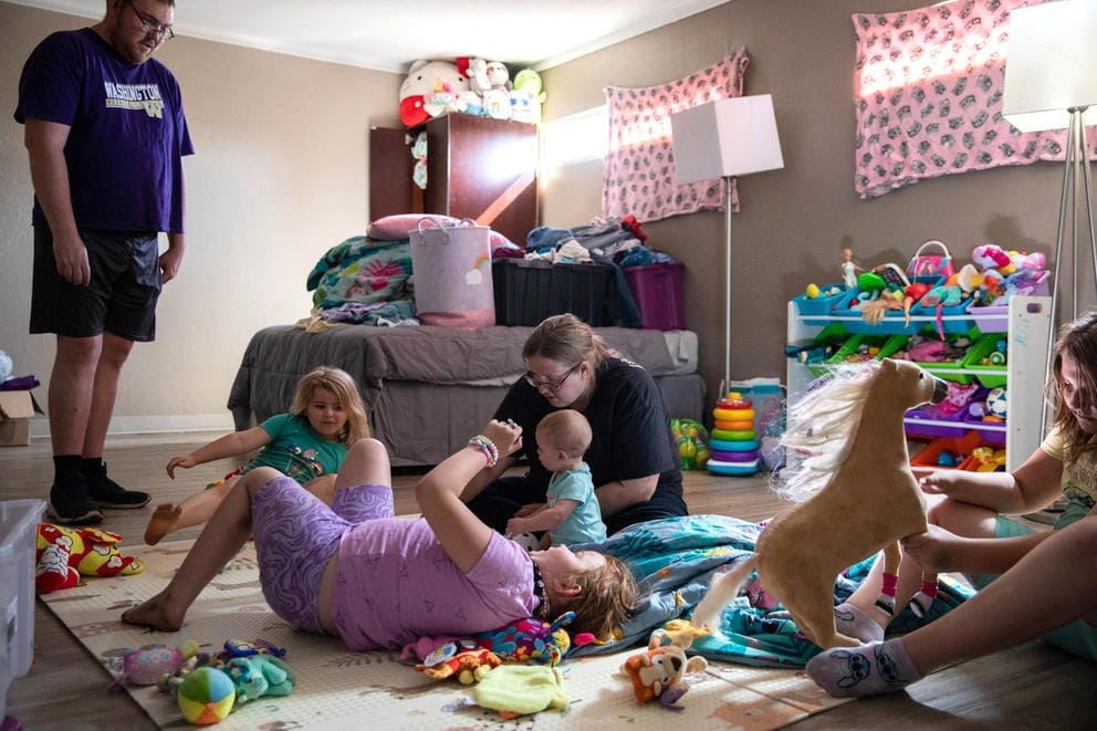 The Blackledge family hangs out in the girls’ room of their apartment