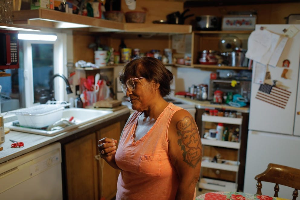 A portrait of Elva Simmons in the kitchen of her mobile home