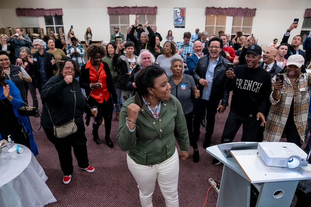 Joy Hollingsworth dances with a crowd of people at an election party